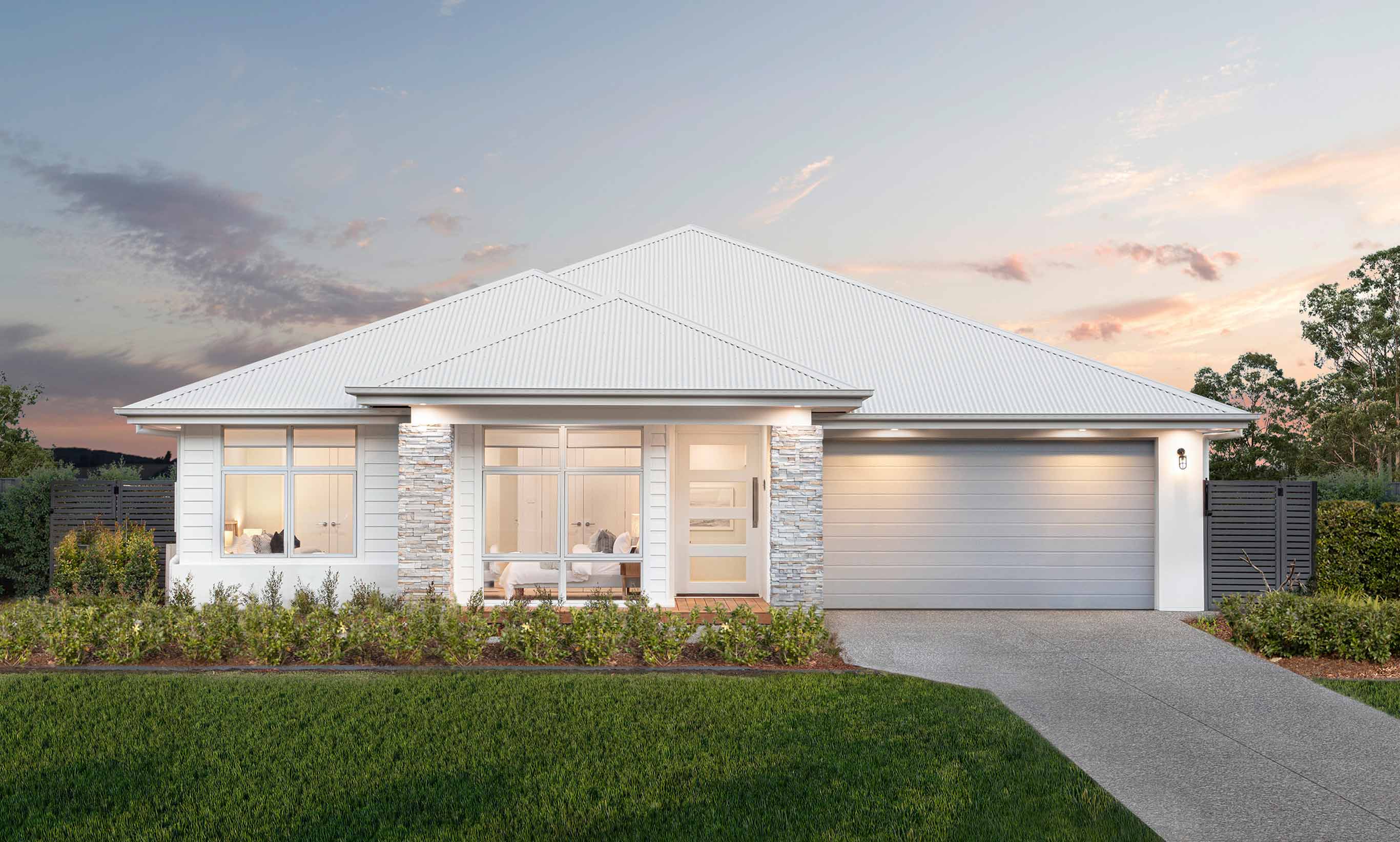 Beautiful coastal exterior photograph of the San Marino Manor on display at Forster features a predominantly white palette with two feature stone stacks in sandy tones with soft grey accents.