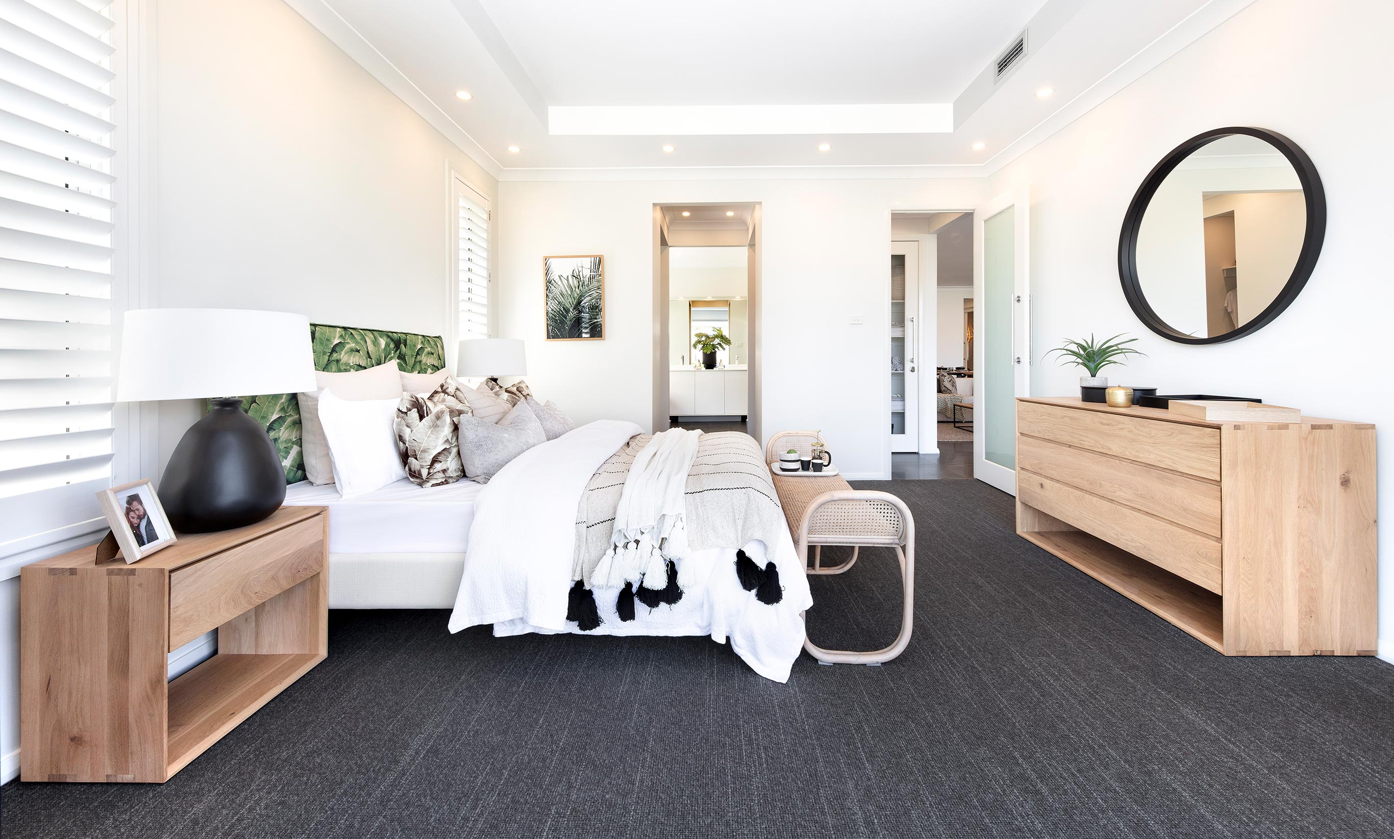 Coastal Bahamas styled Master Suite with timber, rattan and wicker furniture with stacker doors for airy and lightfilled spaces.