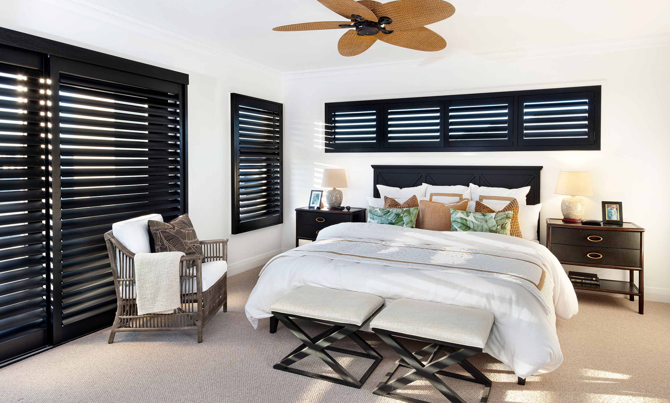 Classic Plantation styled homes are dramatic and use striking fixtures to enhance the livability of the home such as these beautiful dark mocha plantation shtters and teh feature ceiling fan.