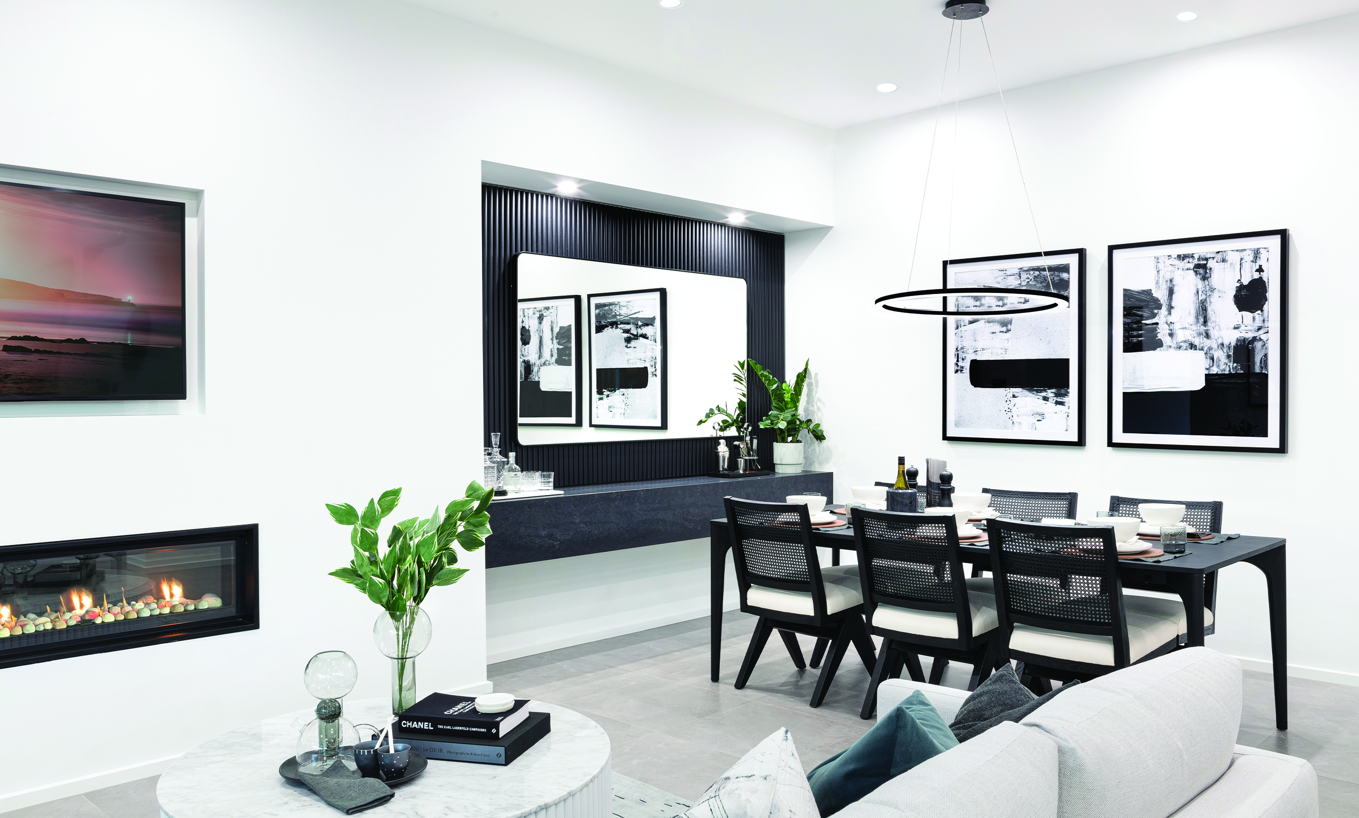 Contempo Modern styling creates a chic dining and living space with dramatic feature lighting, uncluttered surfaces with modern furtiture design against the monochrome palette.