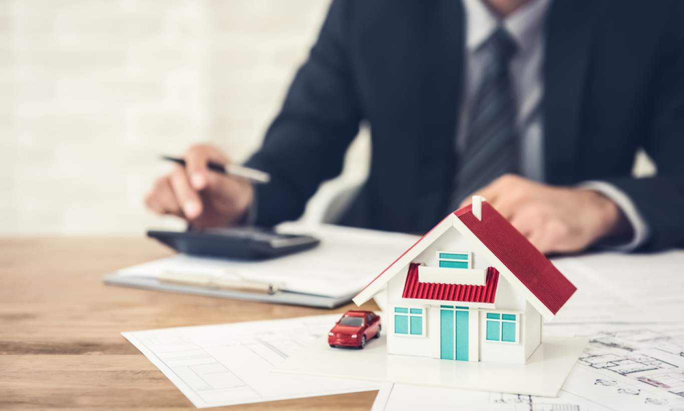 Miniature house model and Financial statement with coins. Finance and house loan, saving money for a house or material design concepts