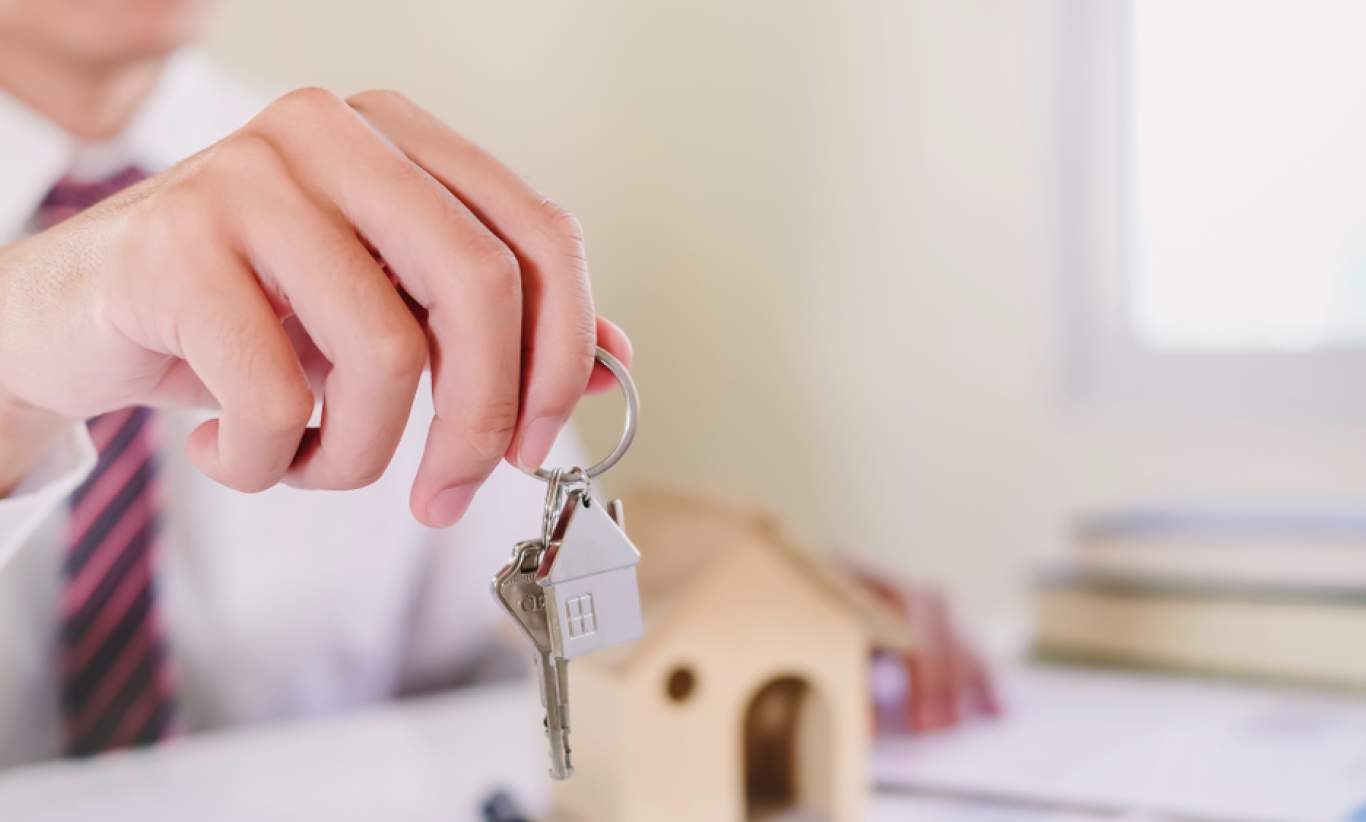 Real estate agent handing over the keys to a home.