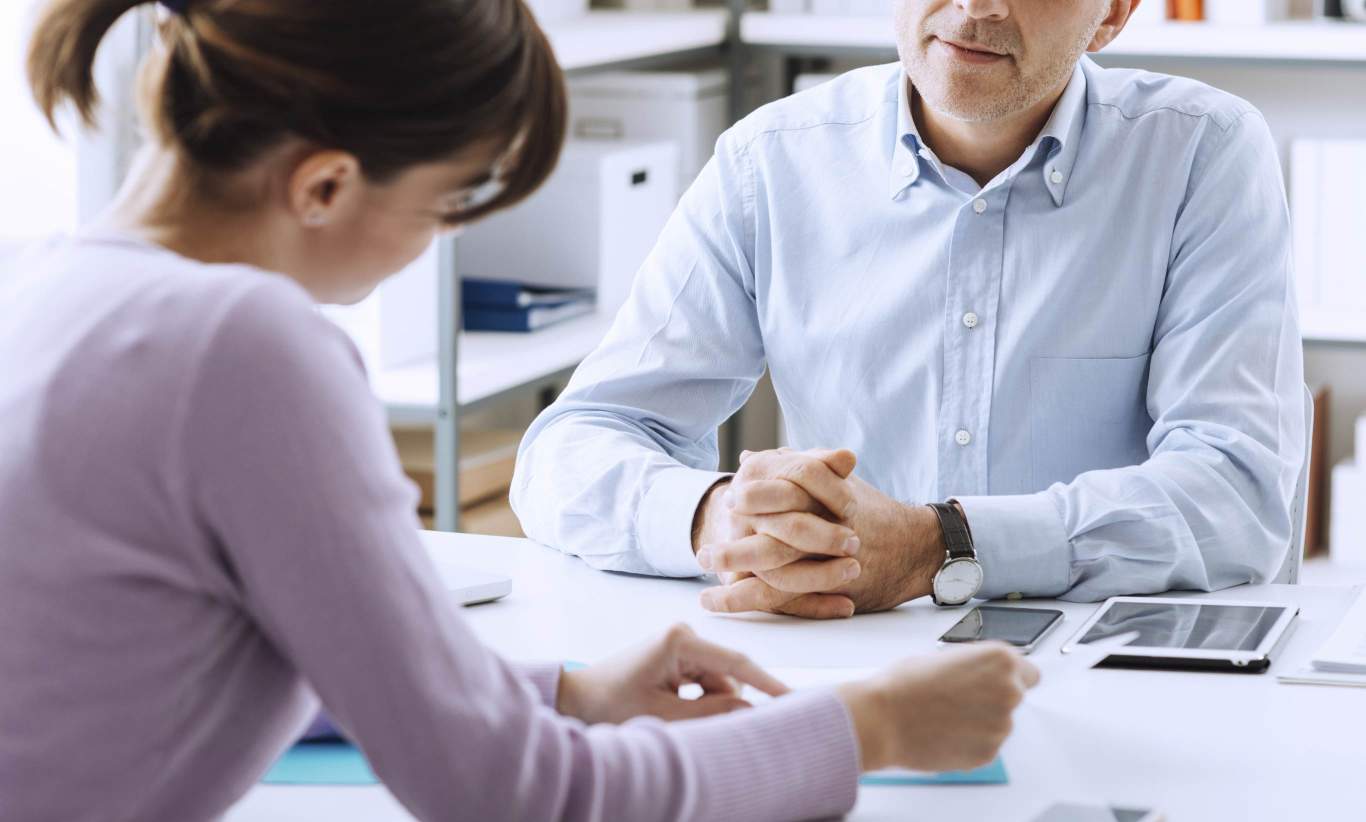 An advisor talking to a client about their first home purchase