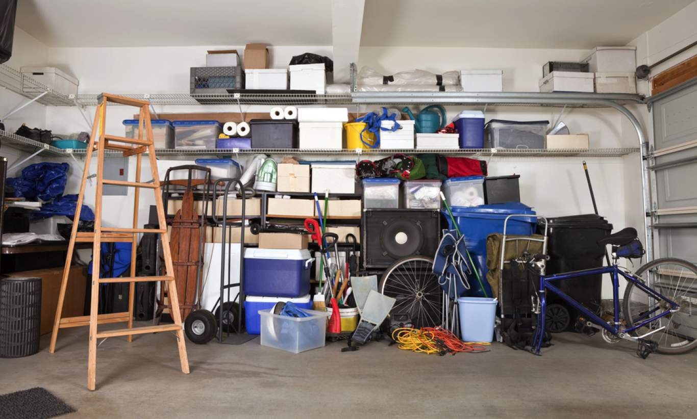 Cluttered garage with toys and boxes scattered