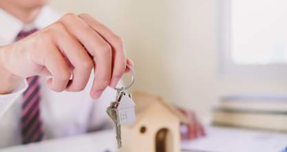 Real estate agent handing over the keys to a home.