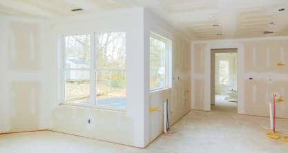 Interior construction of housing project with drywall installed and patched without painting applied