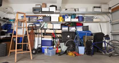 Cluttered garage with toys and boxes scattered