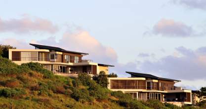 Two similar mansions built into a sloping hill